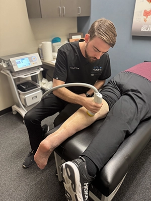 Doctor Using Softwave On Patient